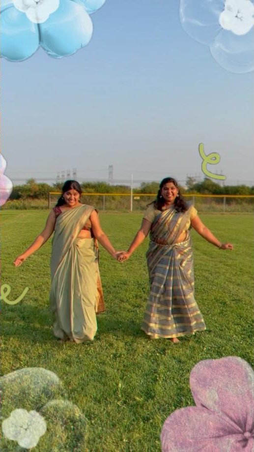 Two dancers in sarees in a field