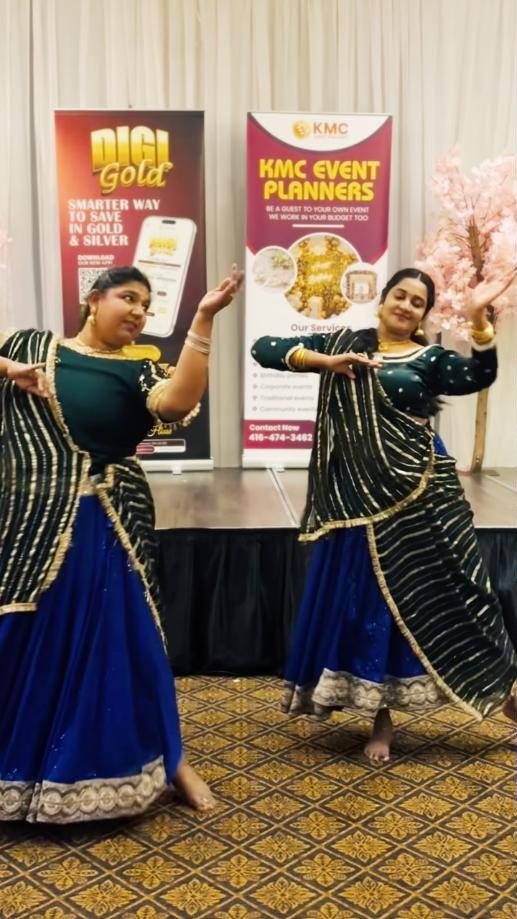 Two dancers performing in green and blue lehengas